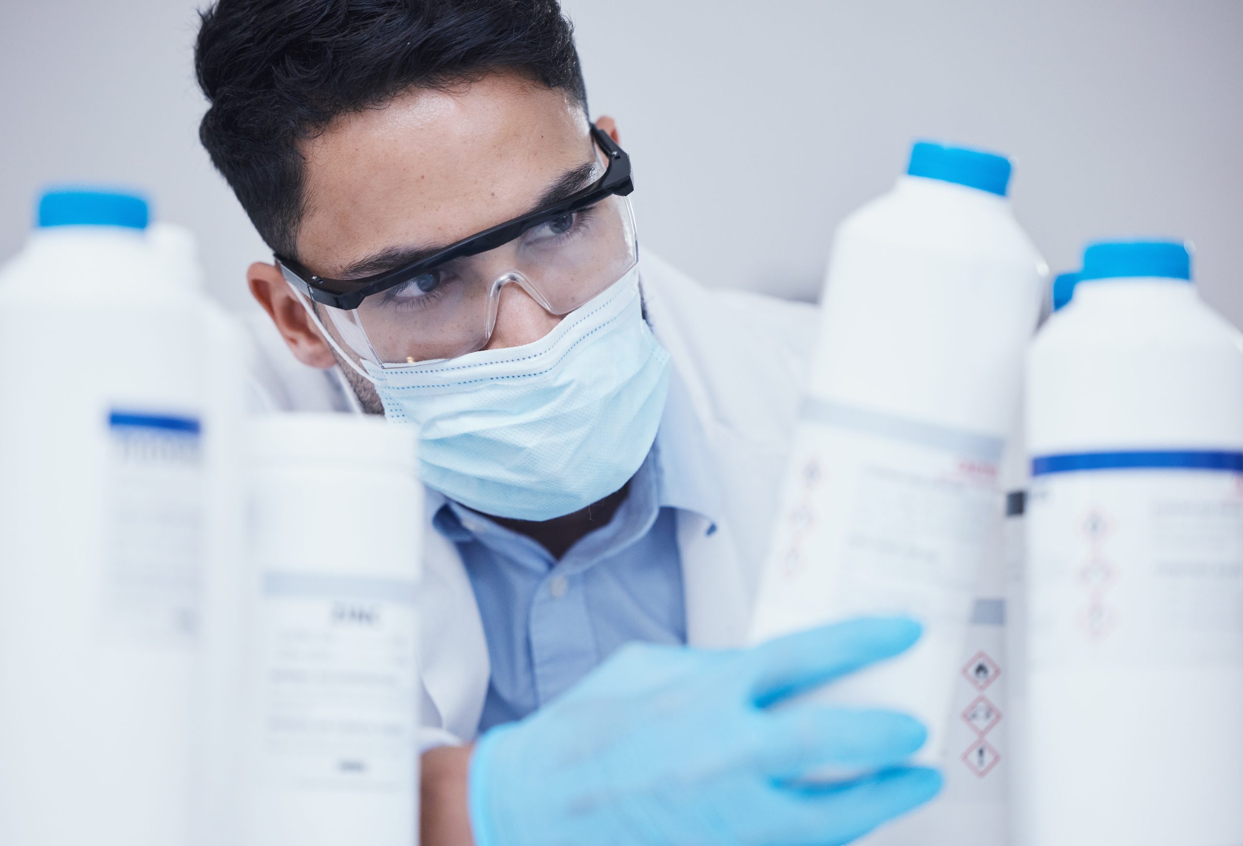container-check-chemical-bottle-and-man-at-scient-2025-04-06-07-11-47-utc