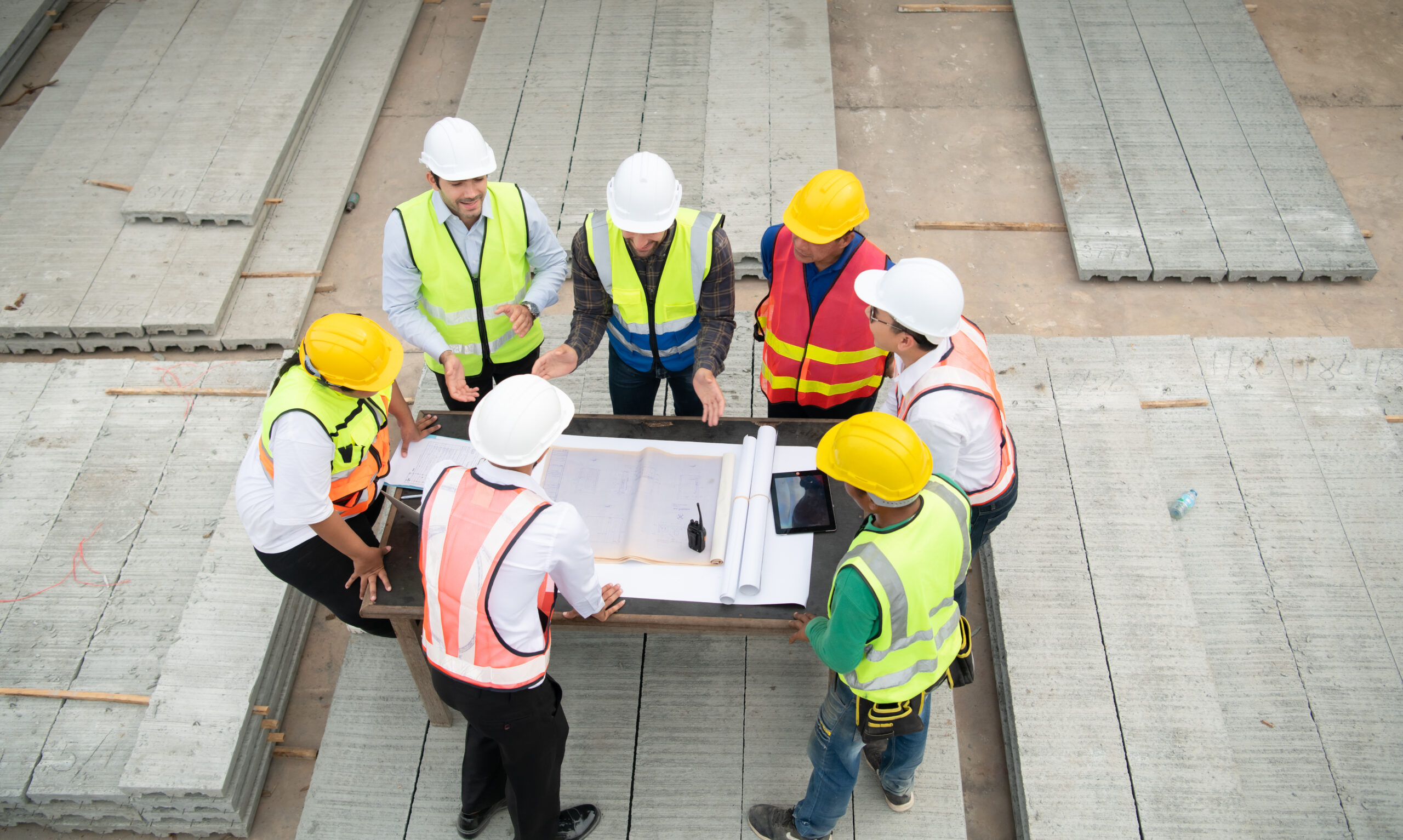 Construction engineers, architects, and foremen form a group. Pa