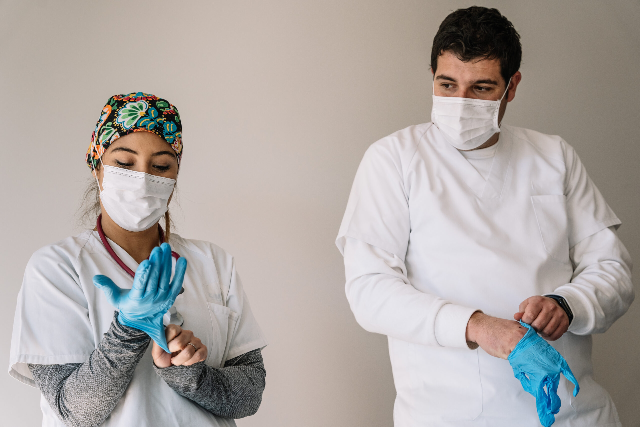 Doctors putting on latex gloves
