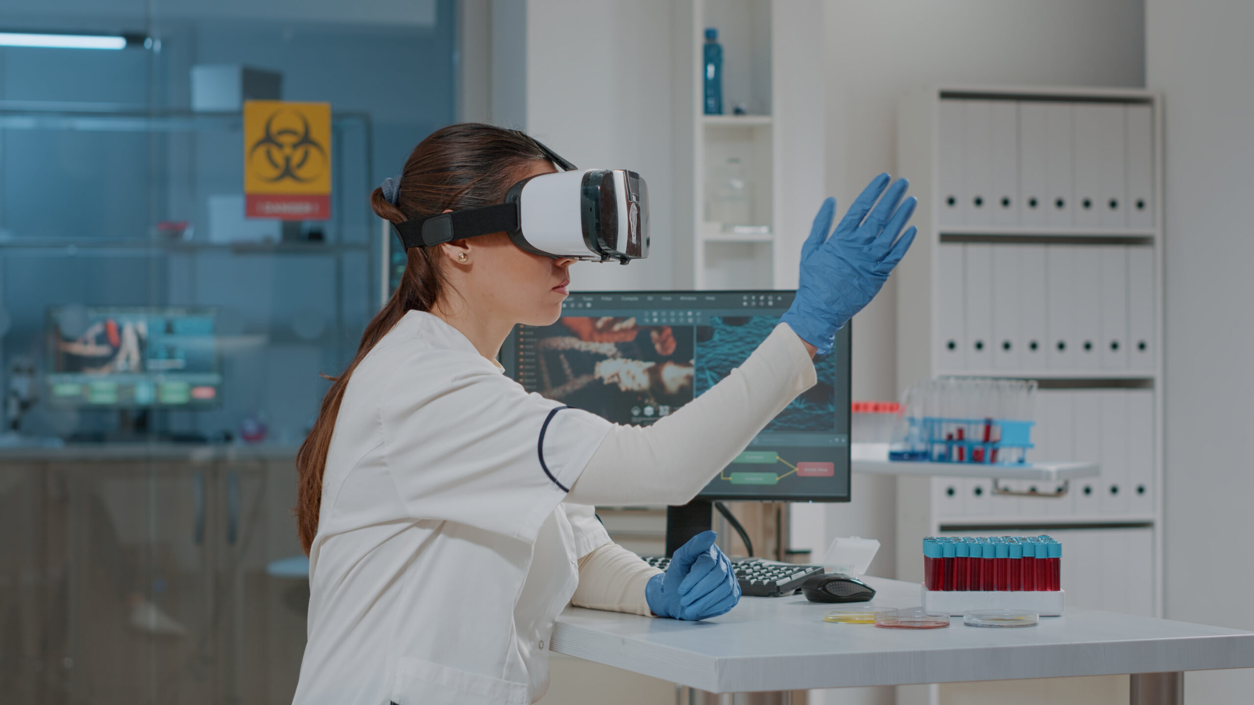 Lab worker using vr goggles with 3d projection in laboratory