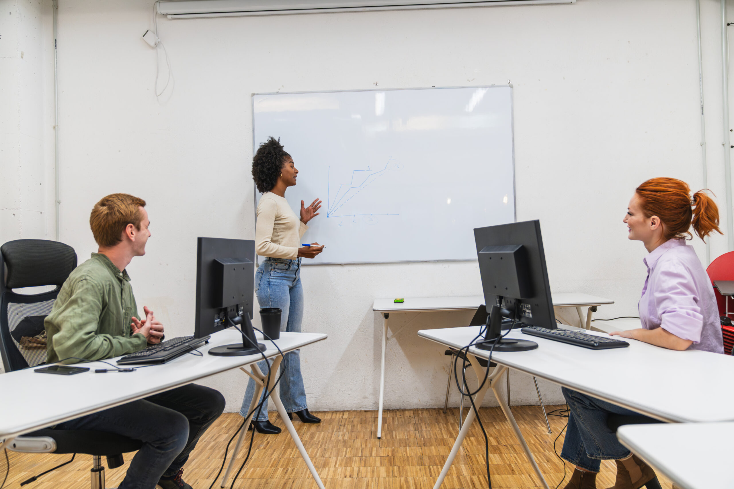 Young professionals collaborating during presentation in modern coworking space