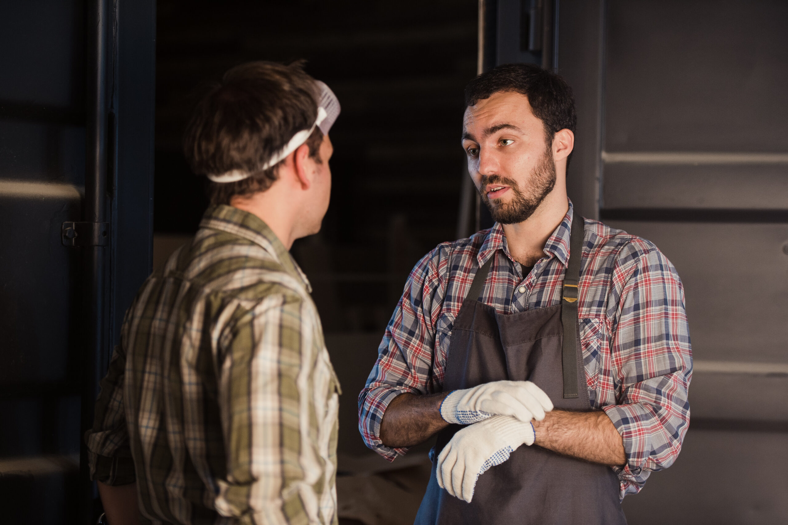 Young carpenter gets money for his work in workshop carpentry