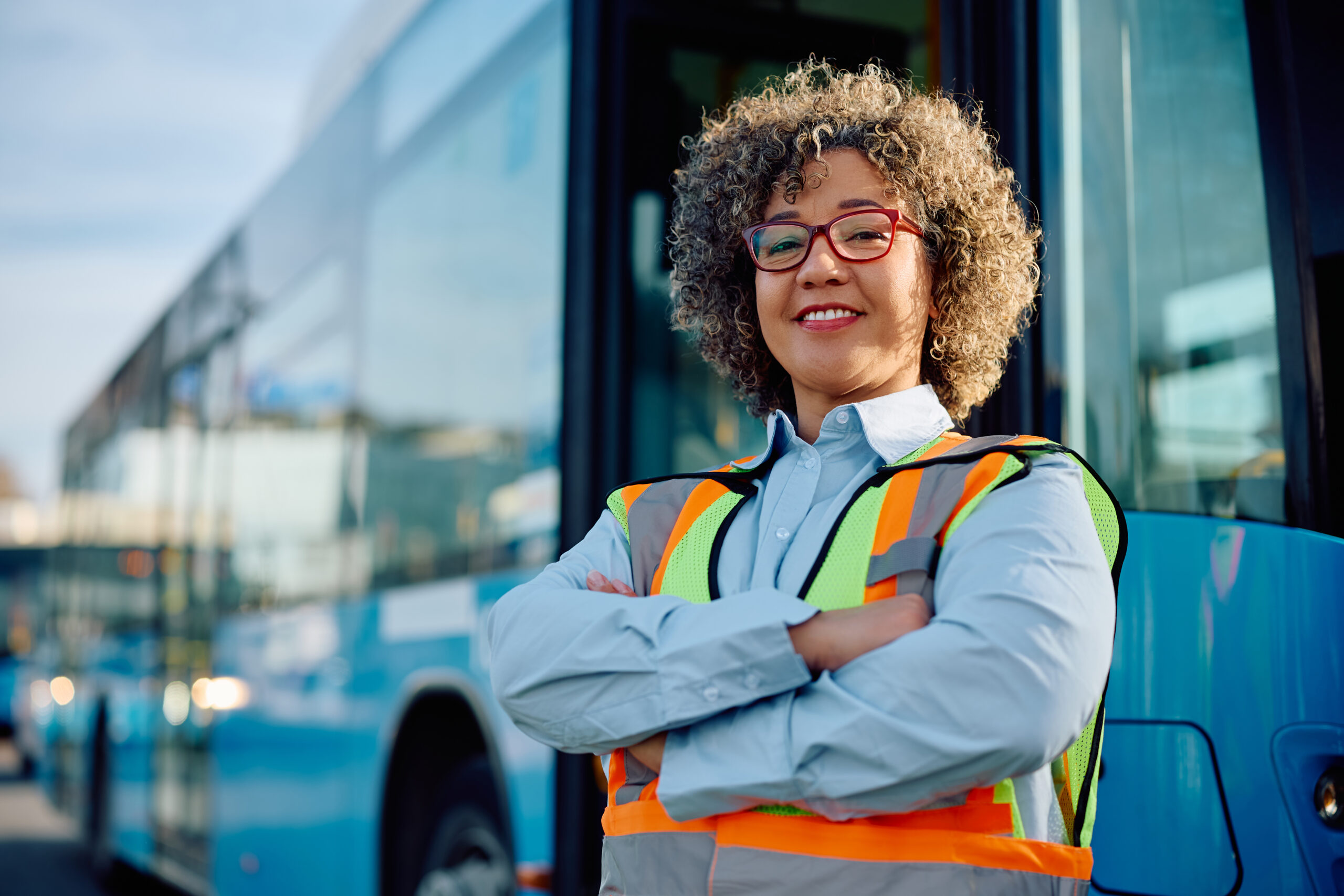 Confident woman working as professional bus driver and looking at camera.