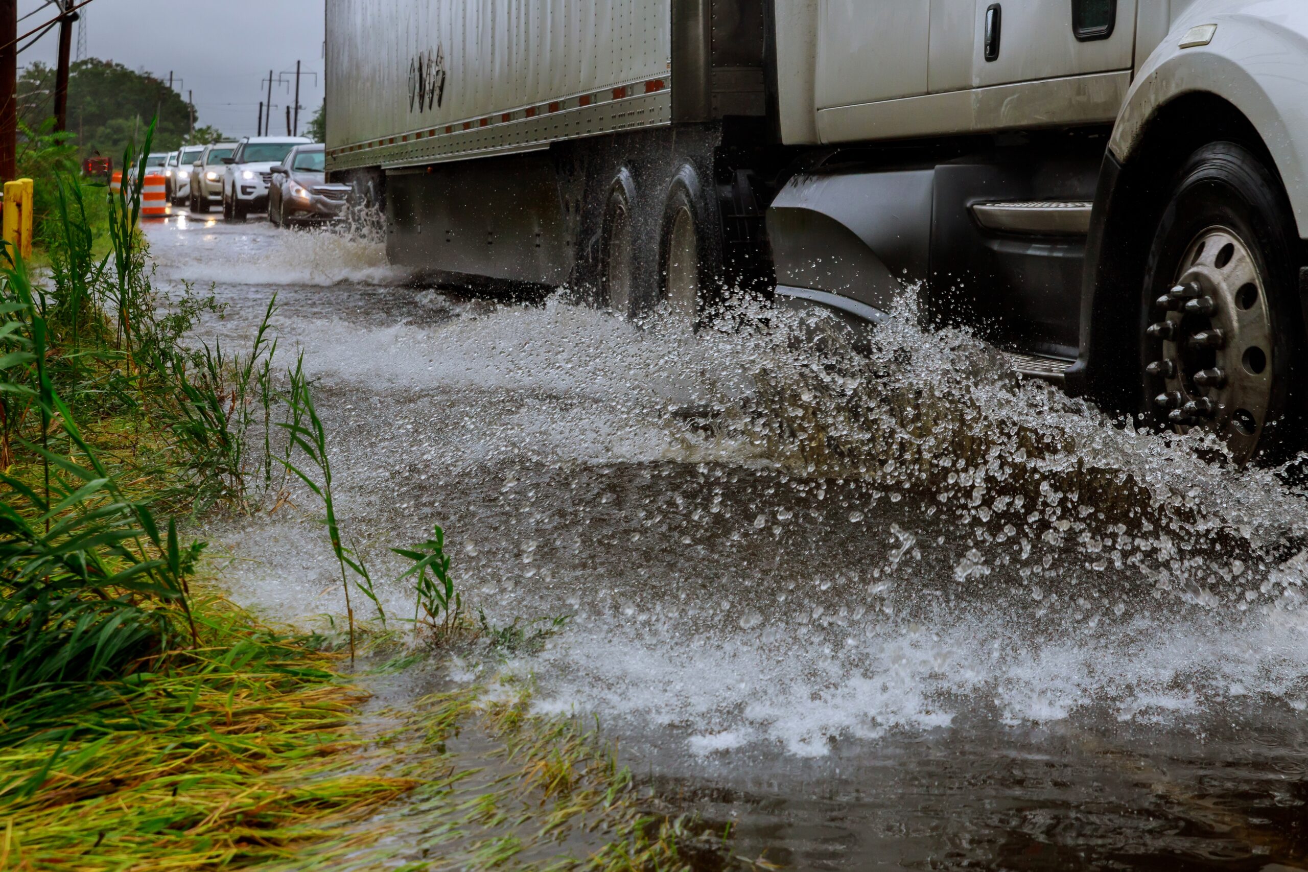Vehicle ignoring road because of flooding car drives through flooded road